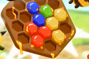 A colorful honeycomb puzzle featuring red, blue, green, and yellow hexagonal pieces dripping with honey