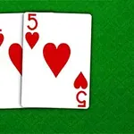 A pair of playing cards featuring the Ace and 5 of hearts on a green textured background