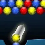 A colorful bubble shooter game featuring clusters of red, blue, and yellow bubbles at the top and a launching device at the bottom ready to shoot a yellow bubble