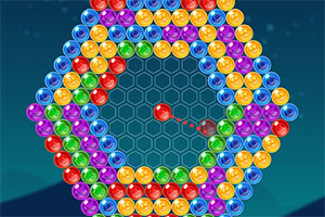 A colorful arrangement of shiny, multi-colored bubbles in a hexagonal pattern on a dark blue background, with a single red bubble in the center aimed at the cluster