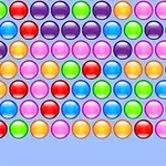 A colorful arrangement of shiny, round bubbles in various hues, set against a light blue background, commonly seen in bubble popping games