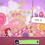 A colorful cartoon-style game scene featuring a character collecting yellow icons, with candy-like background elements, a distance indicator at 500 meters, and two birds perched above