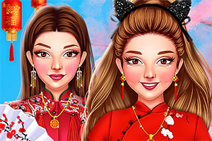 Two smiling young women in red traditional dresses with gold jewelry, one holding a folding fan and the other wearing black cat-ear headband, against a blue background with a hanging lantern
