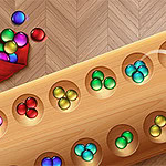 A wooden board with several holes containing colored balls, including green, blue, yellow, and red, alongside a red pouch spilling additional balls