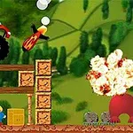 An animated scene featuring a red monster truck launching through the air, a bomb in motion, and an explosion in a colorful landscape with a character standing near stacked crates