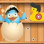 A cartoon blue bird hatching from an egg, flanked by two colorful rubber ducks, with a wooden background featuring bullet holes