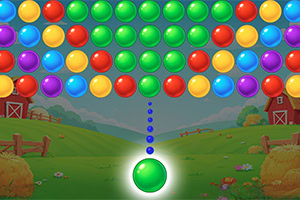 Colorful bubbles arranged in rows over a countryside scene with barns and hay bales, with a glowing green bubble shooter aiming upward from the bottom center