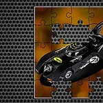 An incomplete jigsaw puzzle featuring a black Batmobile against an orange and yellow background, with a metallic texture border