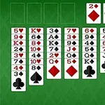 A digital solitaire card game layout featuring multiple stacked cards in red and black suits on a green background