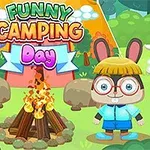 A vibrant cartoon scene featuring a rabbit character with glasses and a sheep character, standing beside a campfire in a green forest setting, with a colorful banner reading Funny Camping Day