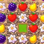 A colorful match-3 puzzle game board featuring various fruits like grapes, strawberries, and pears, along with white flowers, set on a textured background with a vacant green space in the center