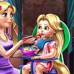 A young mother with long blonde hair wearing a purple dress is feeding her similarly-haired daughter in a colorful room with a bowl of cereal on a high chair