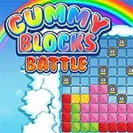 A colorful game interface featuring Gummy Blocks Battle with a grid of gummy-shaped blocks in various colors, surrounded by clouds and a rainbow