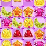 A colorful assortment of jelly candies and sweets arranged on a pink background, featuring shapes like stars, hearts, and gummy worms