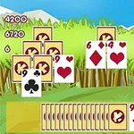 A colorful card game interface displaying a variety of playing cards including diamonds and hearts, set against a backdrop of green grass and mountains