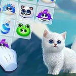 A cute white kitten with big blue eyes stands beside a colorful grid of cartoonish animal icons, including frogs, cats, and other forms, with a hand cursor hovering over them, set against a scenic background