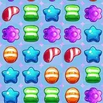 A colorful pattern of various candy shapes, including stars, jelly beans, and gummy shapes in vibrant colors like green, purple, blue, and orange against a light blue background, resembling a fun and whimsical game layout