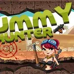 The image features the title Mummy Hunter prominently displayed in bold green letters, accompanied by a cartoon character holding a weapon, set against a backdrop of an ancient desert landscape with pyramid motifs