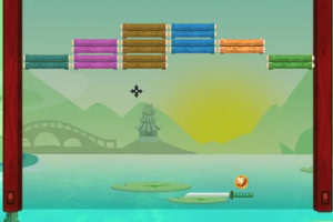 A colorful game interface featuring stacked wooden blocks in various colors against a serene lake and mountain background, with a sun setting and a decorative bridge visible