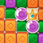 A colorful grid of tiles featuring orange, green, purple, and blue blocks, with decorative shapes and a crown resting above two purple bubbles