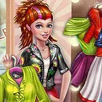 A stylish young woman with colorful hair holds a green shirt, surrounded by vibrant, trendy outfits displayed on hangers in a bright clothing store setting