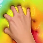 A hand pressing into a colorful, smooth, and shiny surface that features a gradient of vibrant rainbow colors