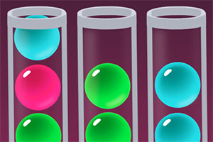 Three test tubes containing colorful spheres: a pink sphere in the left tube, a green sphere in the middle tube, and a blue sphere in the right tube, all set against a dark background