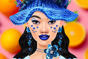 A young woman with a vibrant blue hat adorned with flowers and matching jewelry, featuring bold blue lipstick and decorative blue facial dots, set against a colorful backdrop of oranges