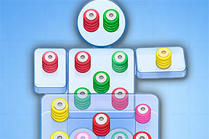 Colorful stacked circular pegs in red, green, yellow, and pink arranged on white rectangular boards against a light blue background