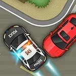 A police car with flashing lights is pursuing a red sports car on a city street, navigating a turn near a crosswalk and greenery