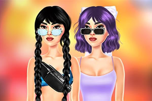 Two fashionable women wearing sunglasses, one with long black braids and a black crop top, the other with short purple hair and a lavender dress, standing against a warm blurred background