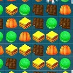 A colorful grid of various desserts including jelly, chocolate, macarons, yellow cake, and green candies, typical of a match-three puzzle game