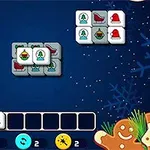 A colorful holiday-themed Mahjong game layout featuring tiles with various Christmas symbols like bells, stockings, and ornaments against a snowy blue background