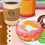 A colorful plate featuring two decorative donuts—one with pink icing and sprinkles, the other with chocolate icing and a cherry on top—accompanied by a coffee cup and a slice of kiwi